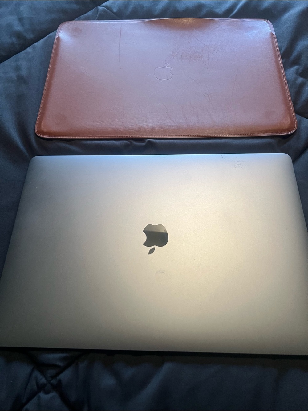 Apple Space Gray MacBook with Brown Leather Sleeve